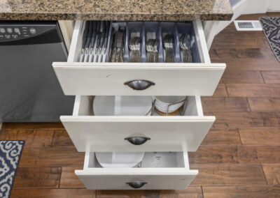 Open drawers with cutlery and dishes