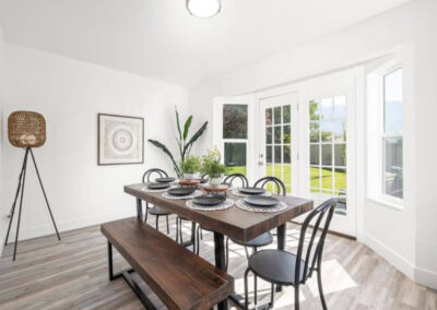 dining table with bench and modern black chairs in home staged for selling