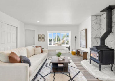 Home Staging in Orem with cream sofa, mid-century modern coffee table and wood burning stove