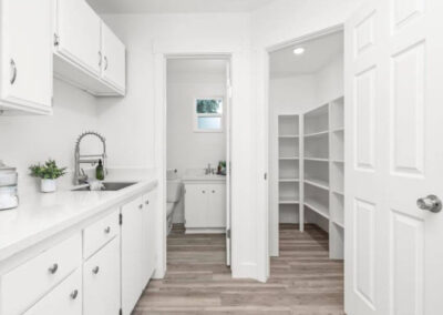 laundry room open with views into closet and toilet area