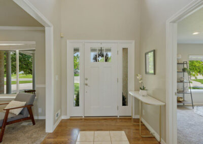 clean uncluttered front door and entry with table and decorations