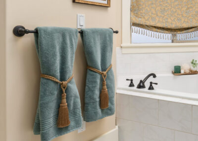 detail of bathtub in elegant bathroom with teal towels