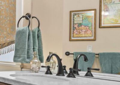 detail of sink in elegant bathroom with teal towels