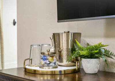 refreshment bar with glasses, ice bucket and candies for guest in elegant vacation rental