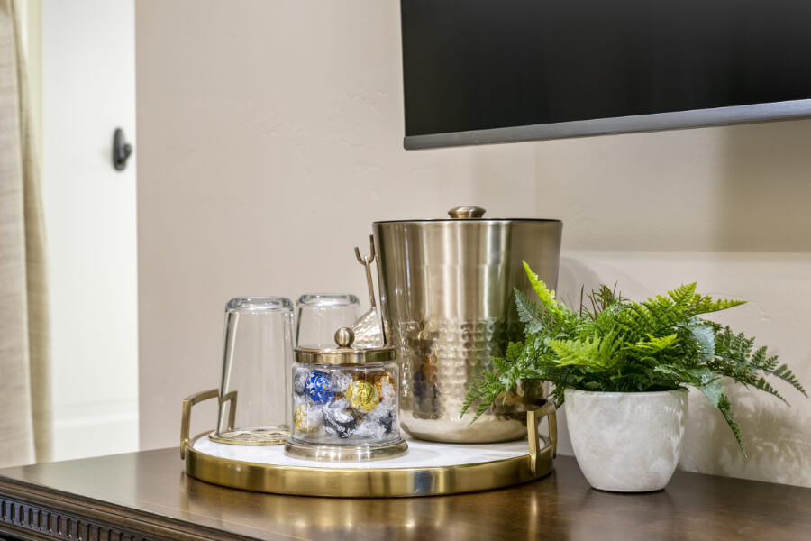 refreshment bar with glasses, ice bucket and candies for guest in elegant vacation rental