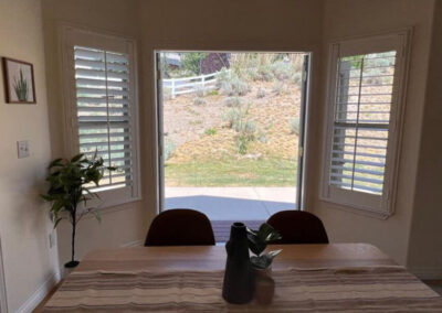 view of mountain hillside out of dining room window with decor staged for selling the home
