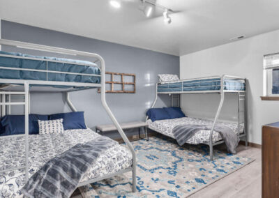 two bunk beds in one room decorated gray and blue