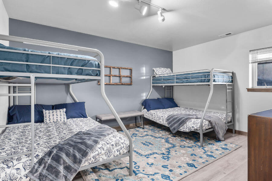 two bunk beds in one room decorated gray and blue