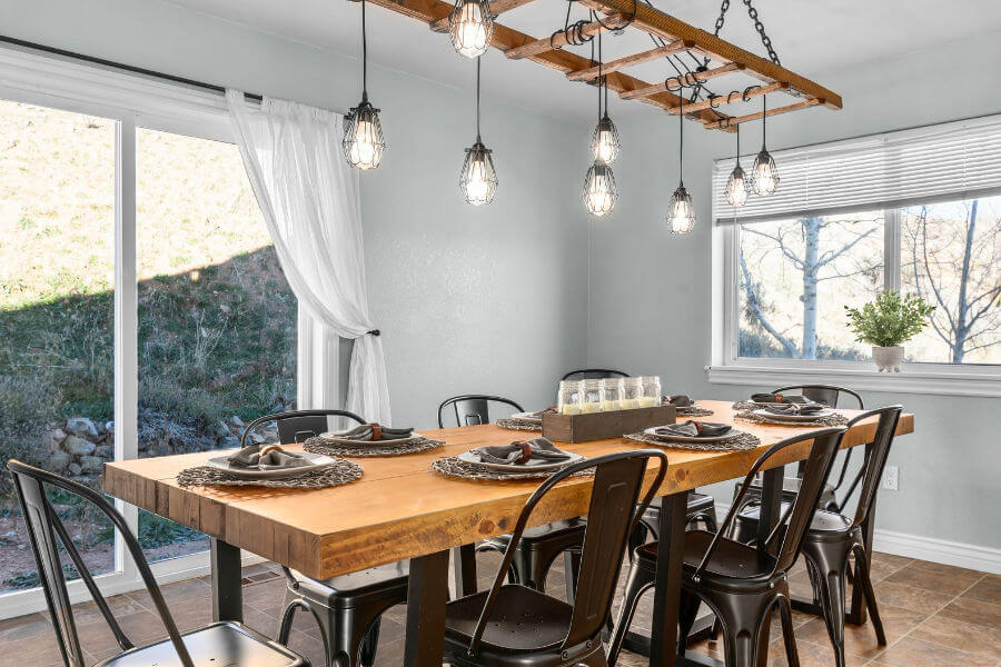 beautiful wooden table with modern industrial chairs and semi-rustic place settings