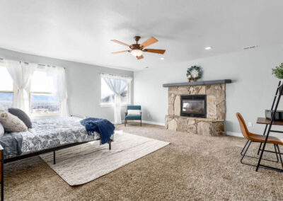 furnished master bedroom with fireplace and mid century modern accents and modern blue colors