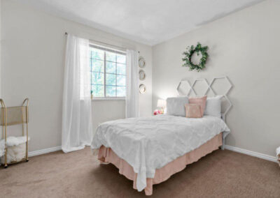 pink and white girls bedroom with full bed and window